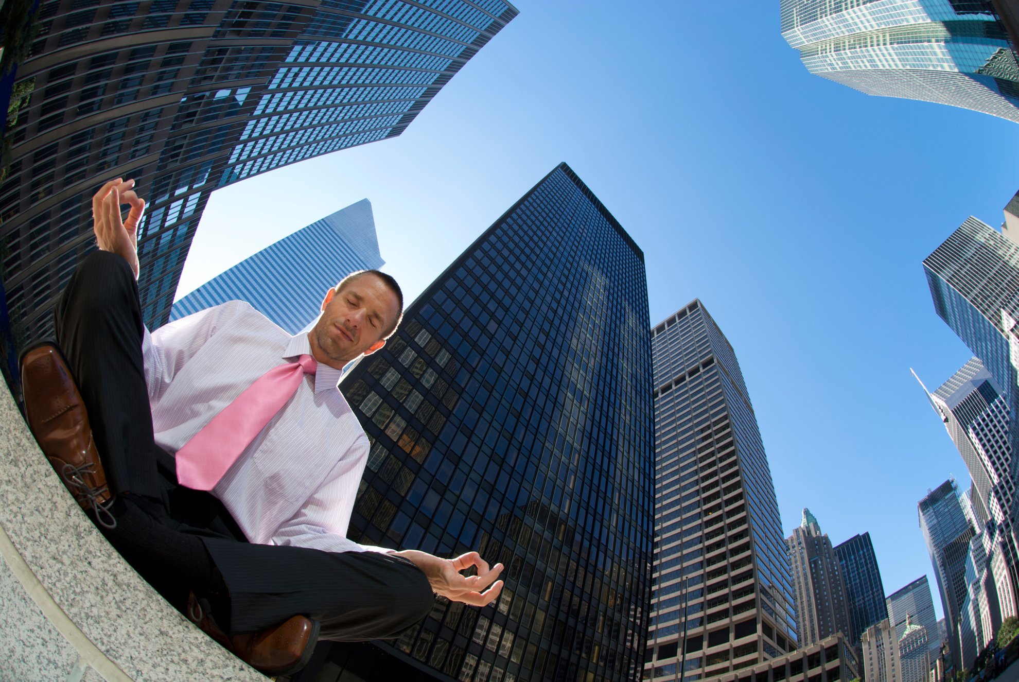 Businessman Meditating Outdoors Doing Yoga in Corporate Canyon